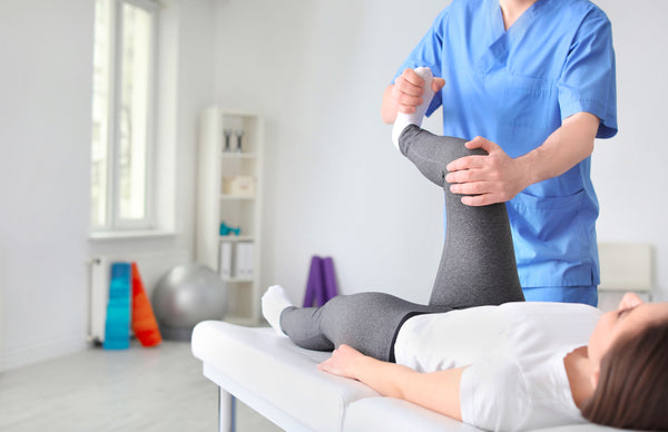 Young woman working with a physical therapist to treat her arthritis