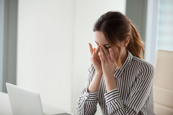 Woman experiencing anxiety in an office