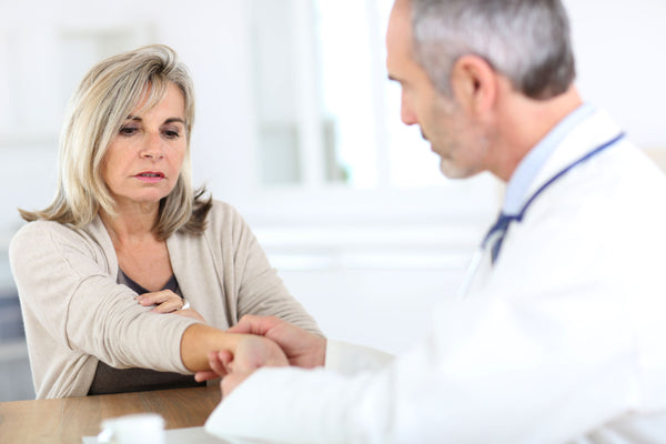 Senior woman consulting with a doctor for her arthritis