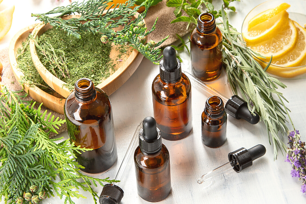 Amber glass bottles filled with essential oils and herbs