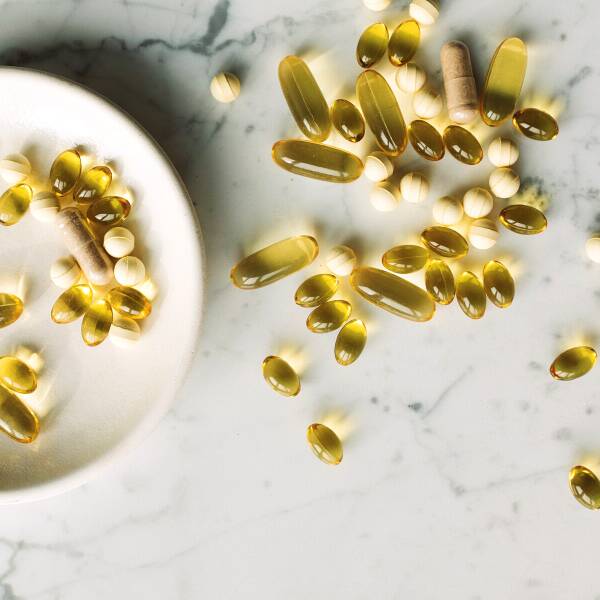 Vitamins and pills for boosting immune system on marble counter