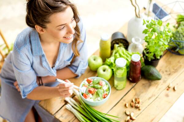 Woman eating healthy salad to boost her immune system