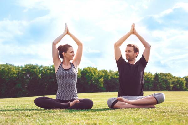 Yoga couple on lawn to boost immune system strength