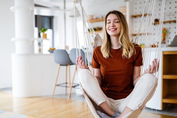 How to Boost Immune System Naturally person sitting in a hammock meditating