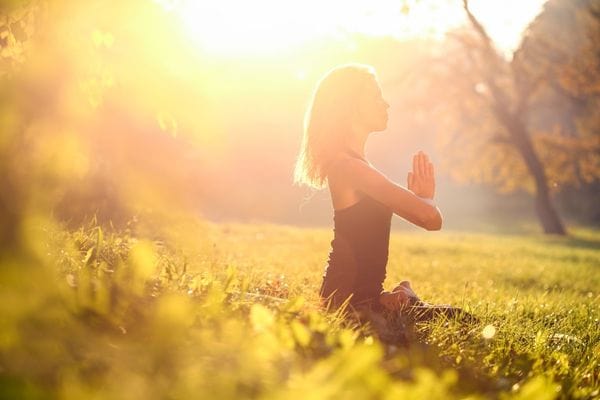 Summer Solstice Wellness Guide your pain free summer starts now woman meditating in the sun