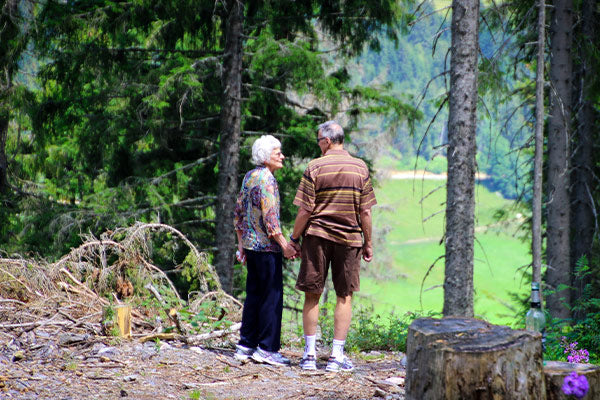 the benefits of blackstrap molasses what is blackstrap molasses elderly couple on a walk hike in the woods on a trail valley view in the background