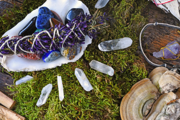 crystal points the benefits how to use them quartz crystal points close up on moss next to other crystals herbs