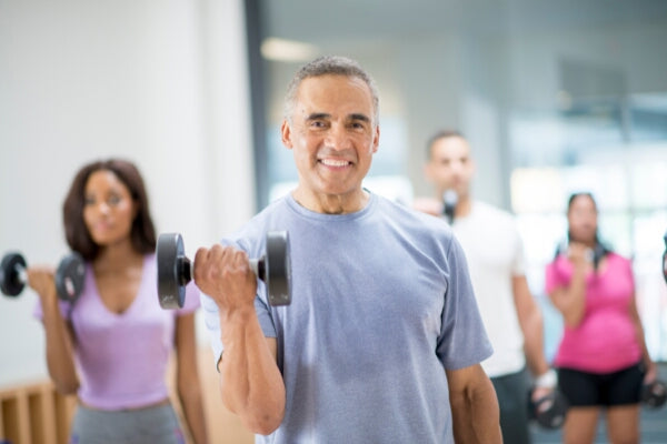how exercise helps protect against bone related illness group of people performing bicep curls