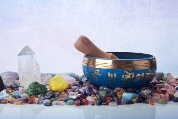 how to charge crystals blue and gold singling bowl sitting on top of a pile of crystals