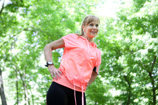 how to improve your focus and concentration woman outside stretching before her exercise green trees in background