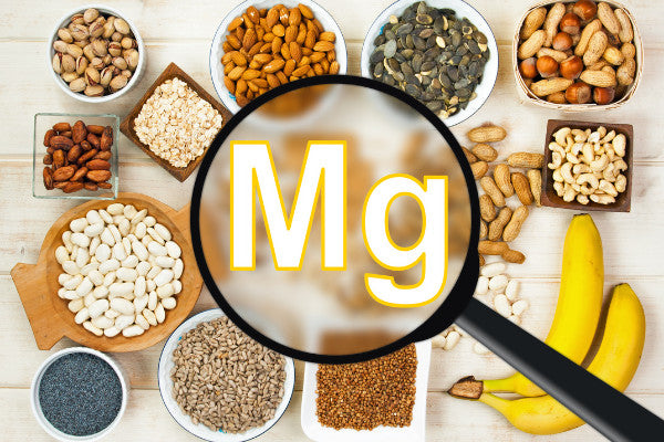 magnesium for back pain is it effective mg under a magnifying glass with magnesium rich foods in the background