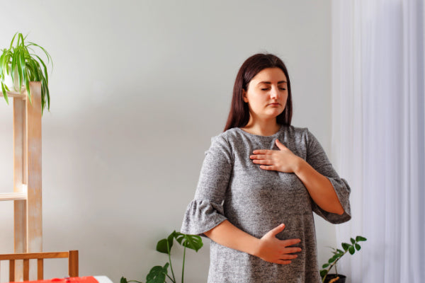 the best breathing techniques for stress relief person practicing 4-7-8 belly breathing technique close up