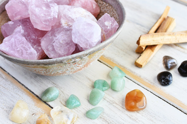 the best ways to decompress after work rose quartz in a bowl with healing crystals around it