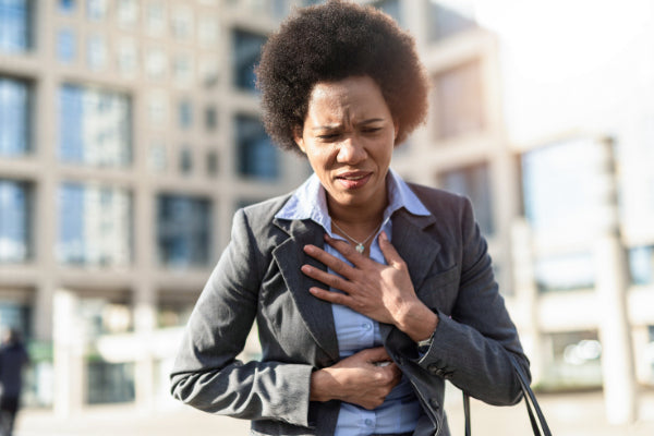 the relationship between anxiety and pain can anxiety cause chest pain person holding chest in front of business