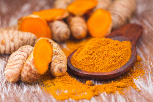turmeric health benefits turmeric essential oil benefits turmeric root and powder on a table