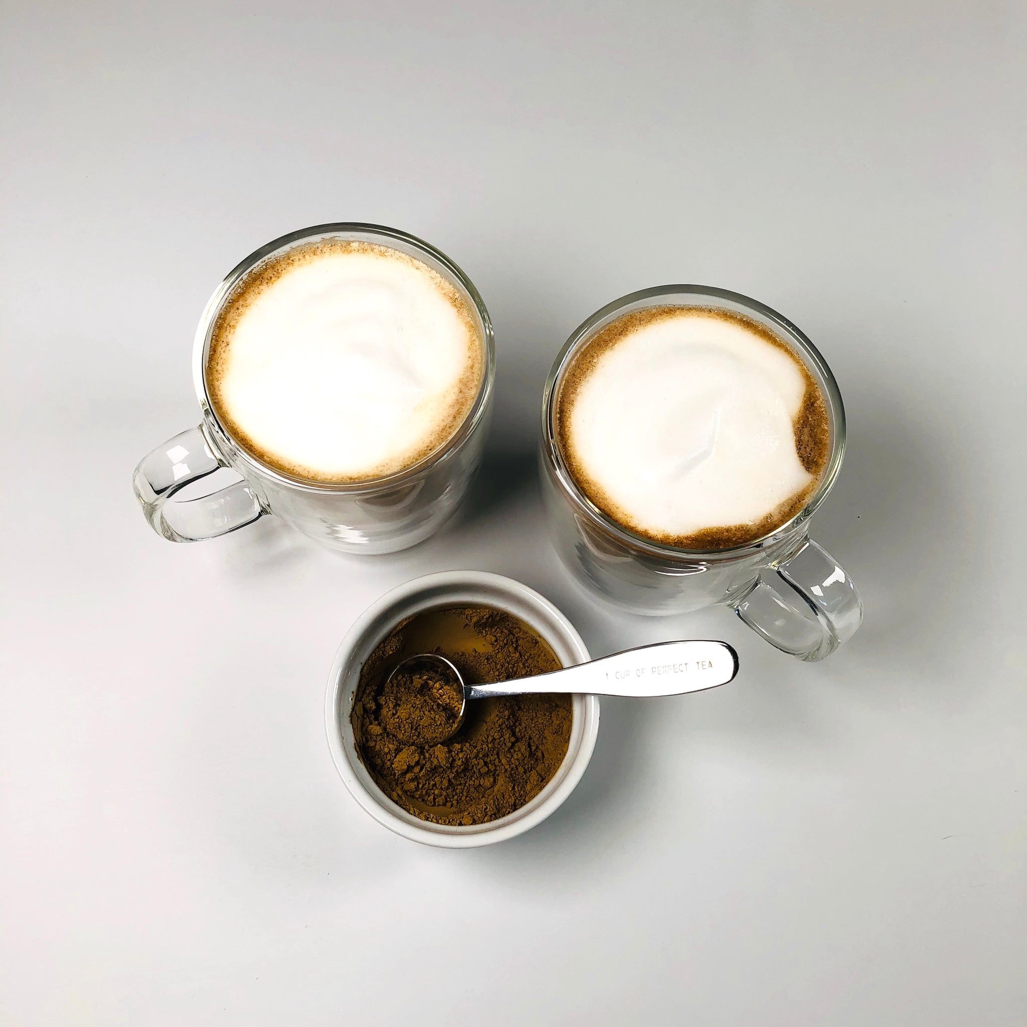overhead shot of earl grey lattes and latte powder