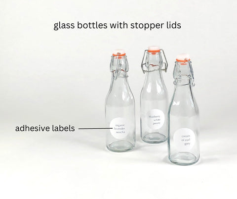 empty stopper bottles with tea labels