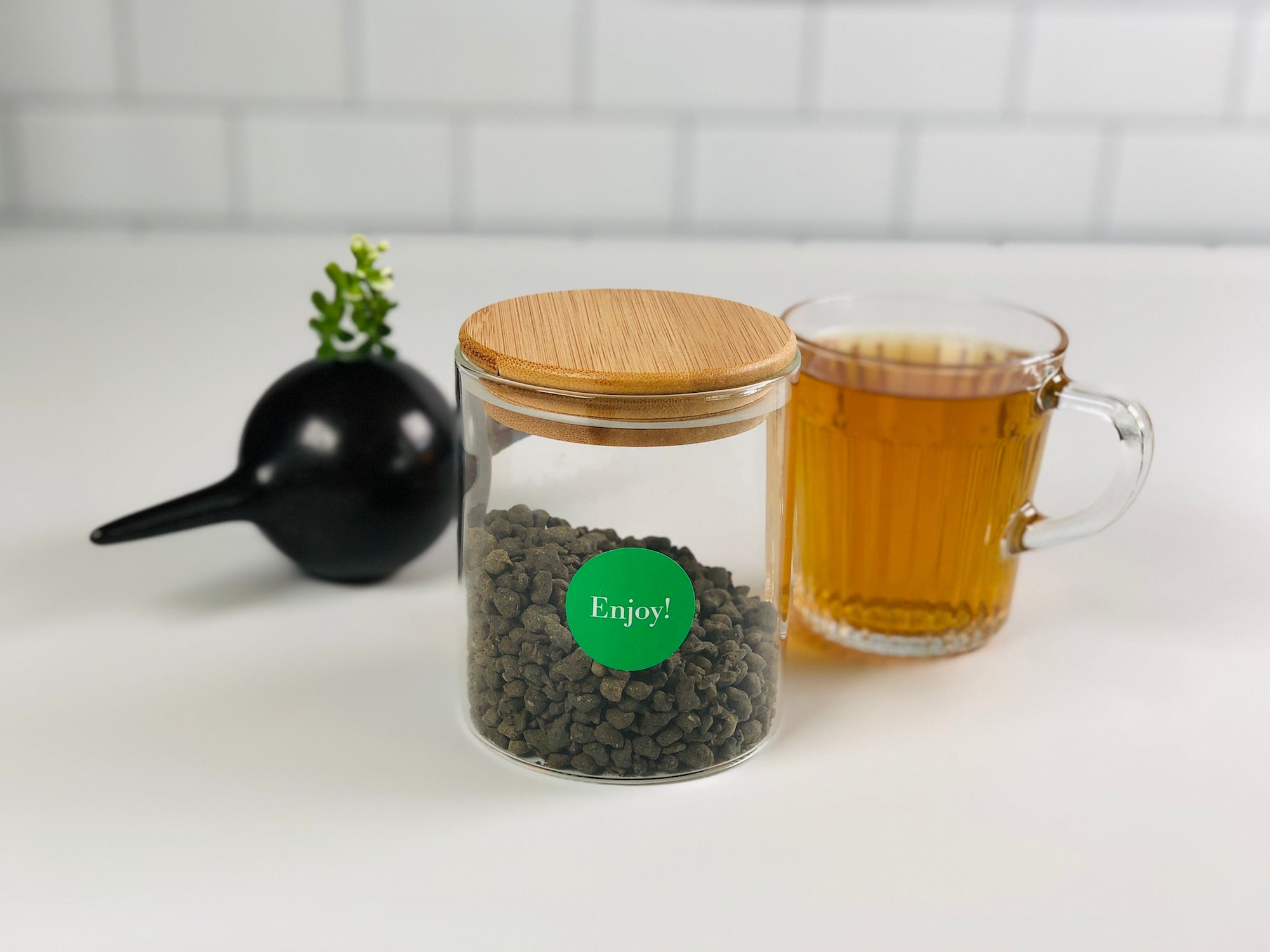 dollar store jar with loose-leaf tea and cup of brewed tea