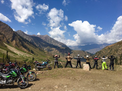 Liza Miller and women's motorcycle riding group pose for strong image