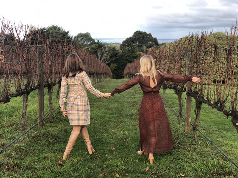women in vintage style clothes explore orchard and winery