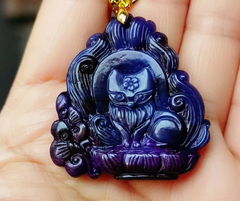 A picture of a carved sugilite pendant