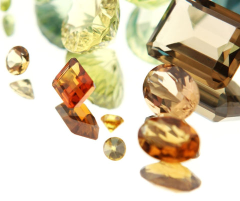 a variety of brown crystals cut into gems