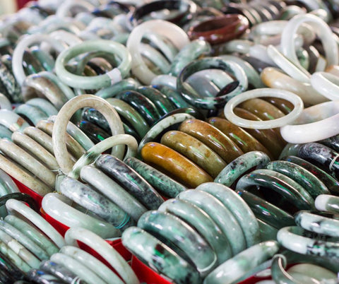 Many colours of Jade bangles in a market stall