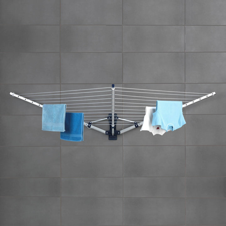 A rust proof aluminium clothes airer on a grey tiled wall