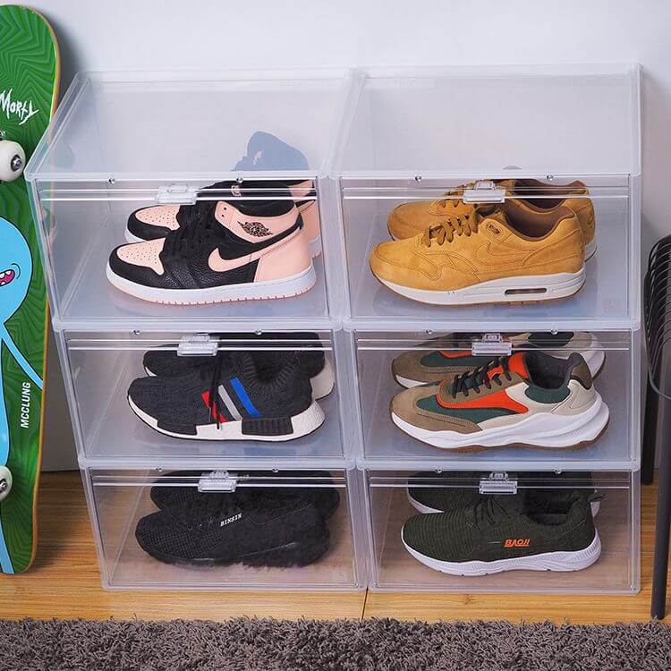 Siz large sneaker storage boxes. There are two columns of three stacked boxes. Inside each box is a pair of colourful high-top sneakers.