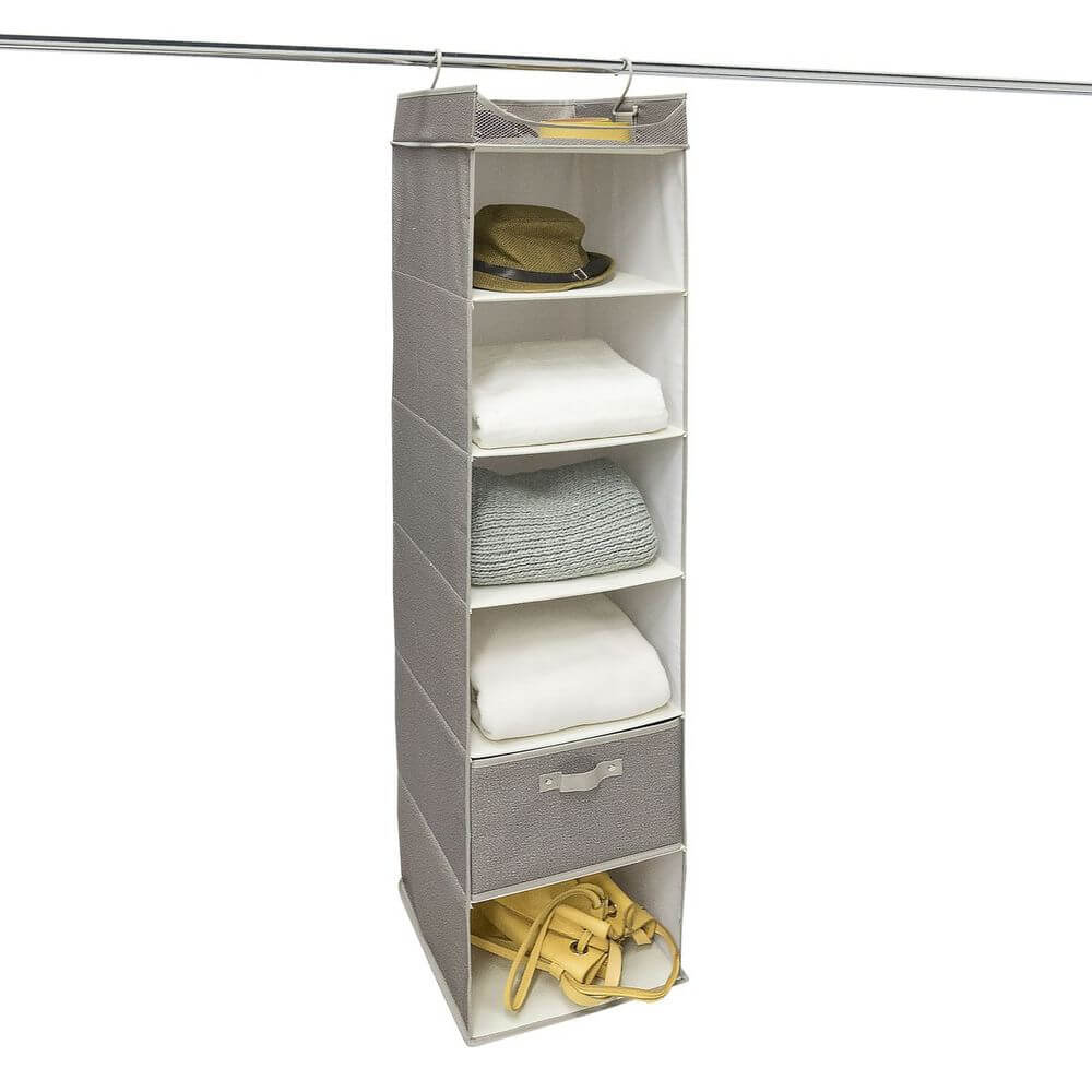 A grey hanging wardrobe organiser. There are six shelves, with clothes and accessories stored inside.