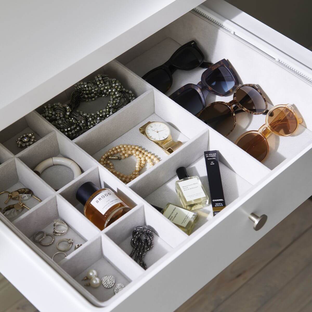 An Elfa jewellery storage tray used to organise jewellery, glasses and watches in an Elfa Gliding Mesh Wardrobe Drawer