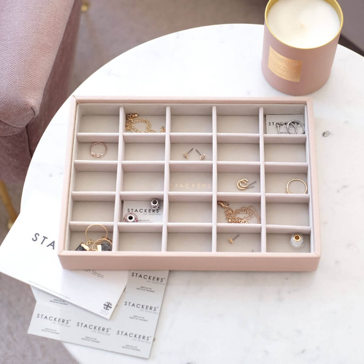 A jewellery storage tray with anti-tarnish strips in each organising compartment