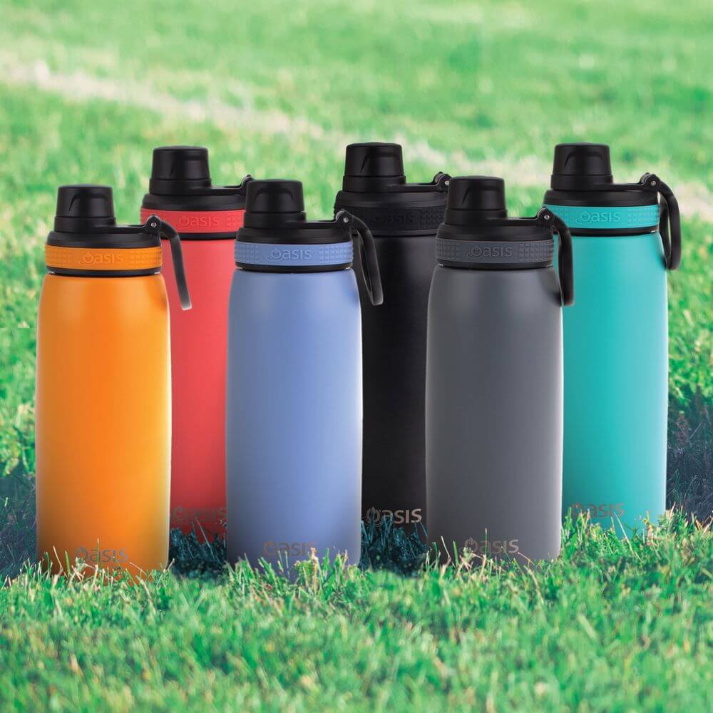 Six insulated sports drink bottles on a grass oval. The bottles are orange, red, purple, black, grey and green.