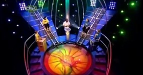 DAve Benson Phillips on Get Your Own Back with contestant hovering above the vat of gunge