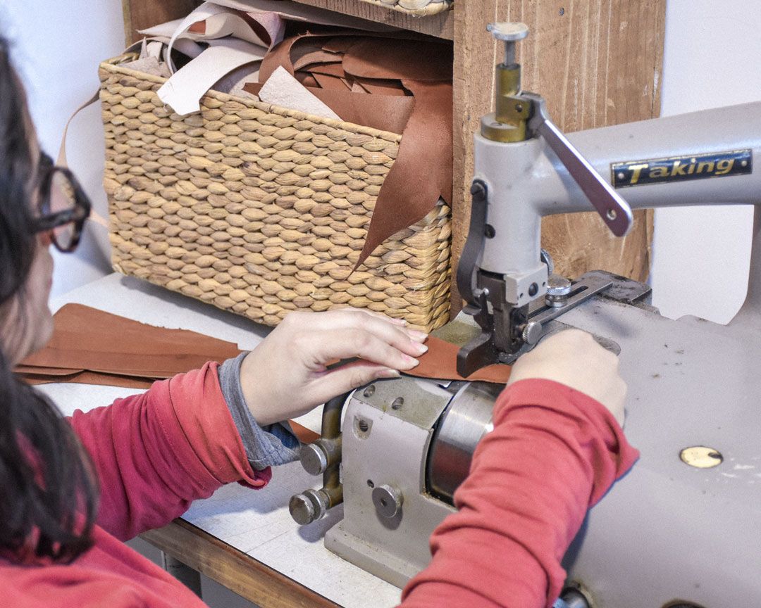 Simone working with a sewing machine to stitch a bag