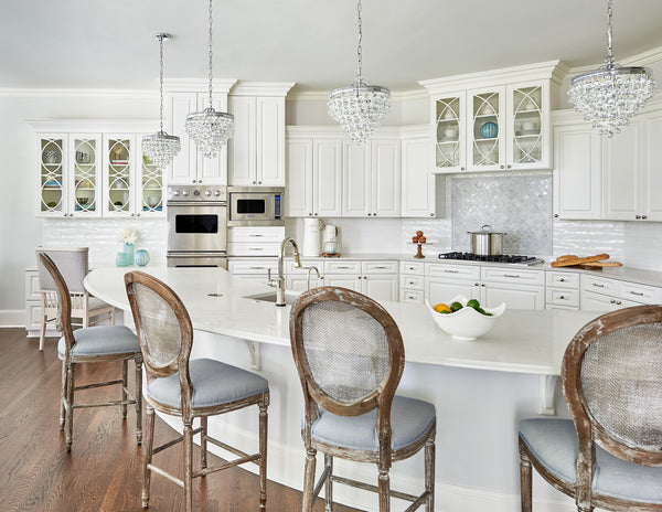 A series of Mini Crystal Chandeliers above a transitional style kitchen island.