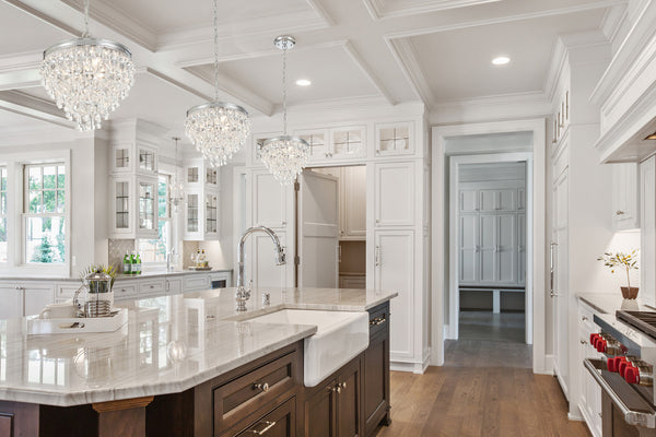 A series  of Mini Crystal Chandeliers showcased above a kitchen island.
