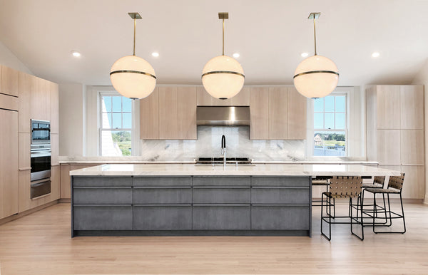 A series of Mid-Century Modern Style Globe Pendant Lights above a modern kitchen island.