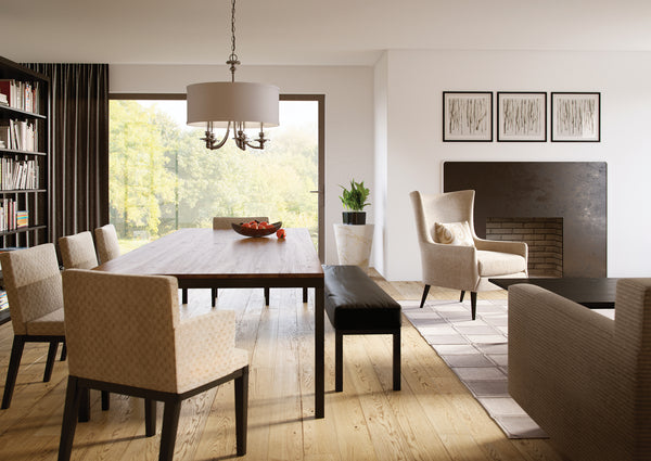 Transitional style drum shade chandelier showcased above a dining table.