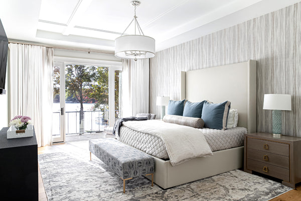 A drum shade chandelier showcased as a centerpiece in a modern bedroom setting.