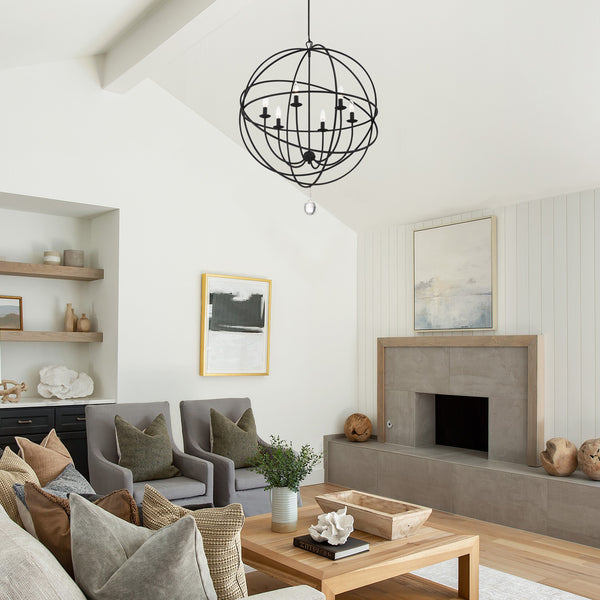 Spherical chandelier hanging like a modernist sculpture in a contemporary living room setting.