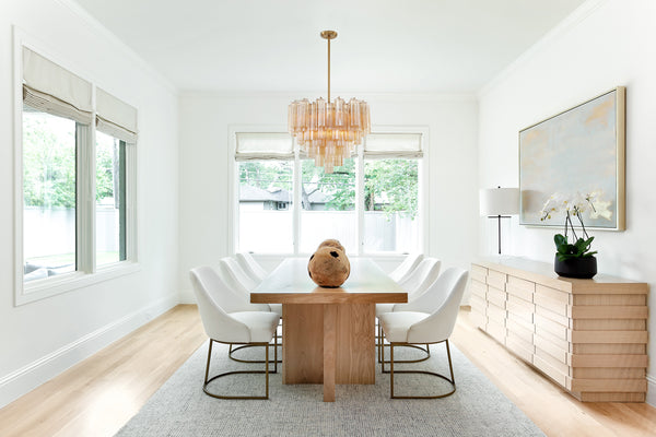 A crystal chandelier showcased in a modern style dining room.