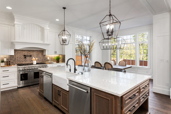 A Pair of Mini-Chandeliers Above A Kitchen Island