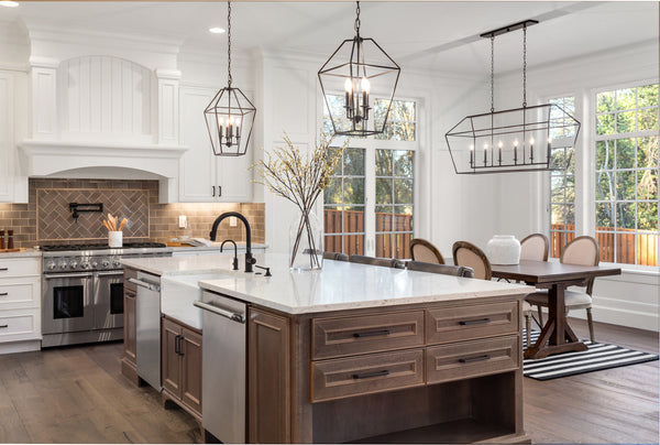 Transitional style chandeliers above kitchen island and dining table.