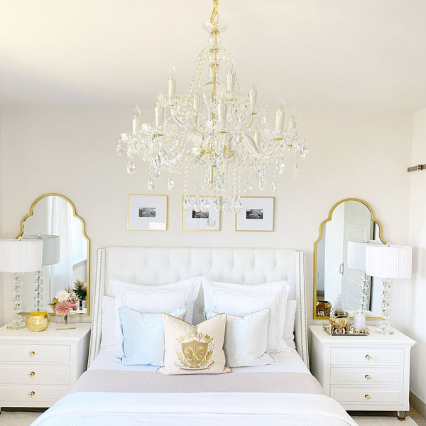 Crystal chandelier showcased as a bedroom centerpiece.