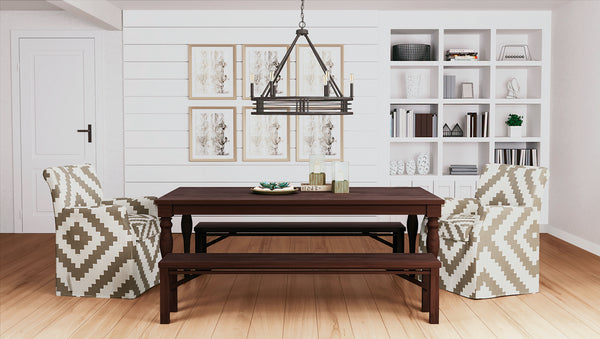 A modern industrial style chandelier above a dining table.