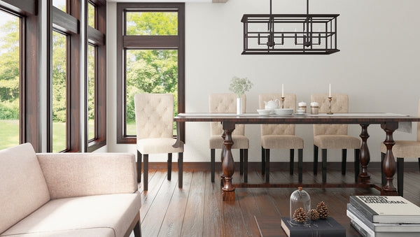 A contemporary style chandelier above a dining a table in a traditional style setting.