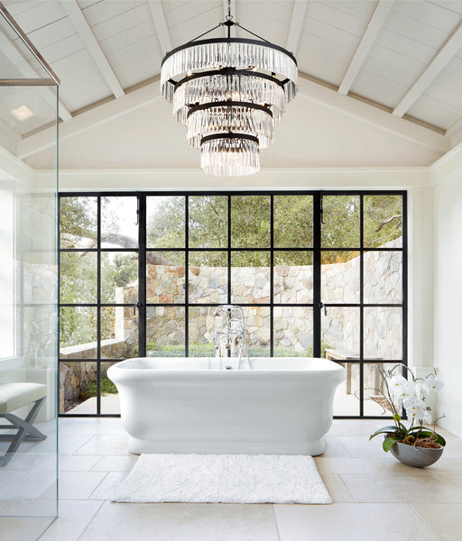 A modern crystal chandelier showcased as a focal point in a modern farmhouse style bathroom.
