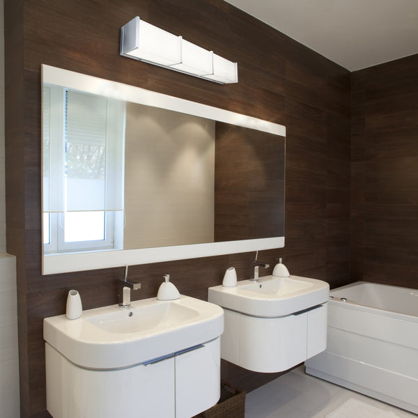 A linear bathroom vanity lighting fixture showcased above a dual sink in a modern bathroom setting.