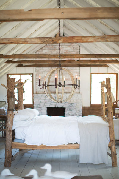 Farmhouse Style Bedroom Featuring a Farmhouse Chandelier.